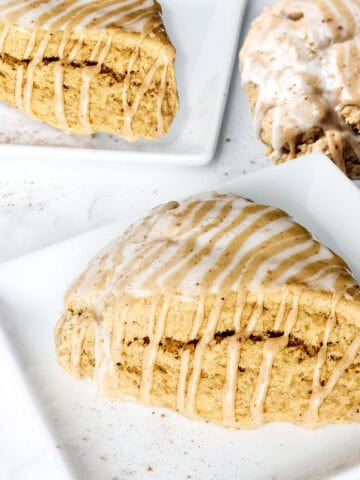 Pumpkin spice scones plated on table.