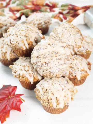 Maple Brown Sugar Oatmeal Muffins piled on table.