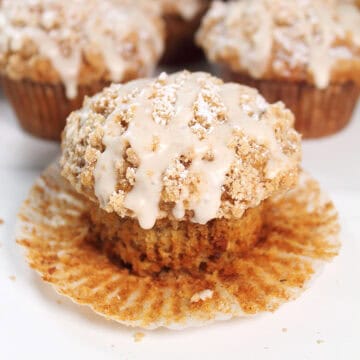 Single maple oatmeal muffin with wrapped peeled back.