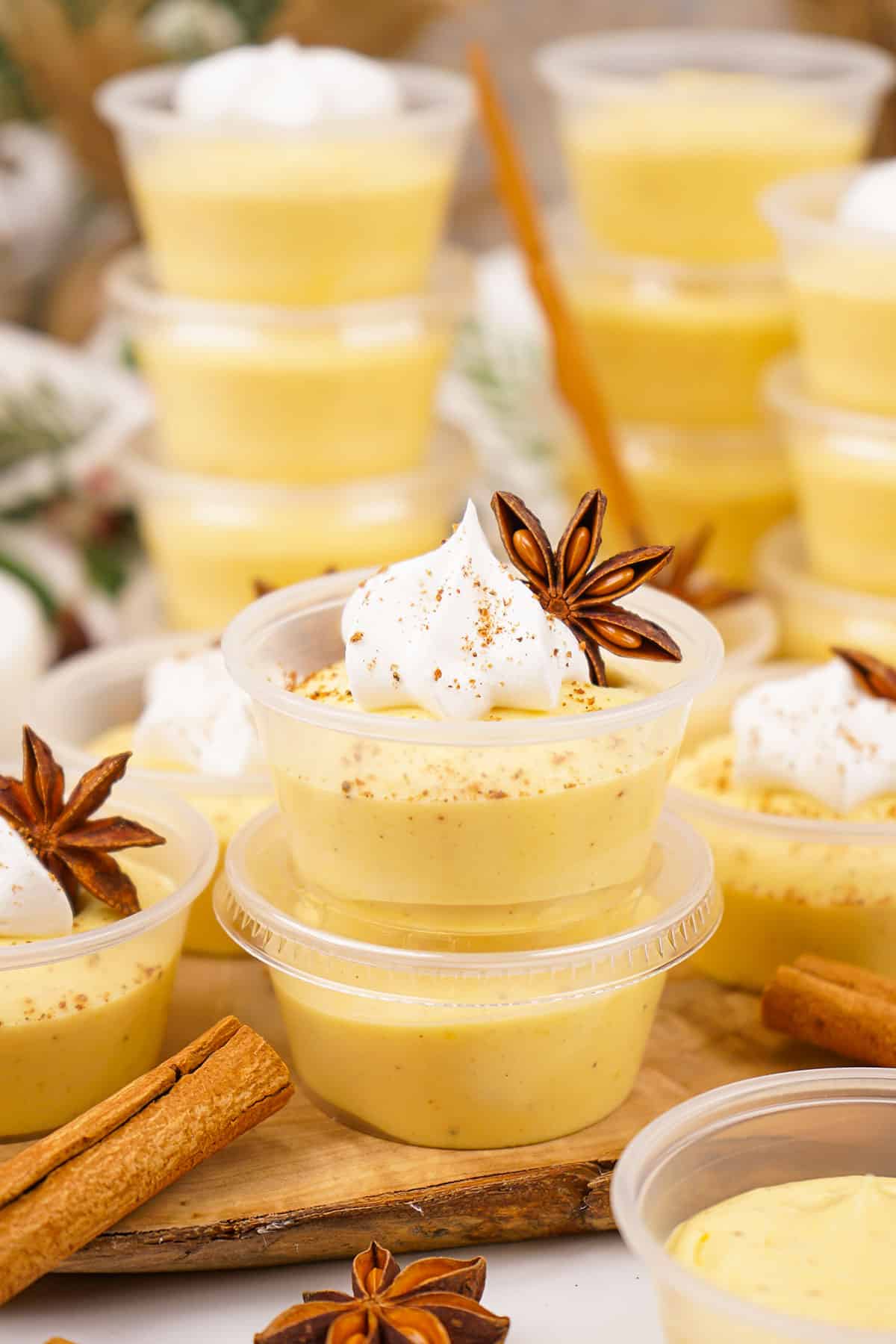 Stacked Eggnog Pudding Shots with two in front.