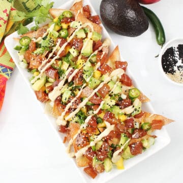 Plated Ahi Tuna Nachos drizzled with wasabi mayo.