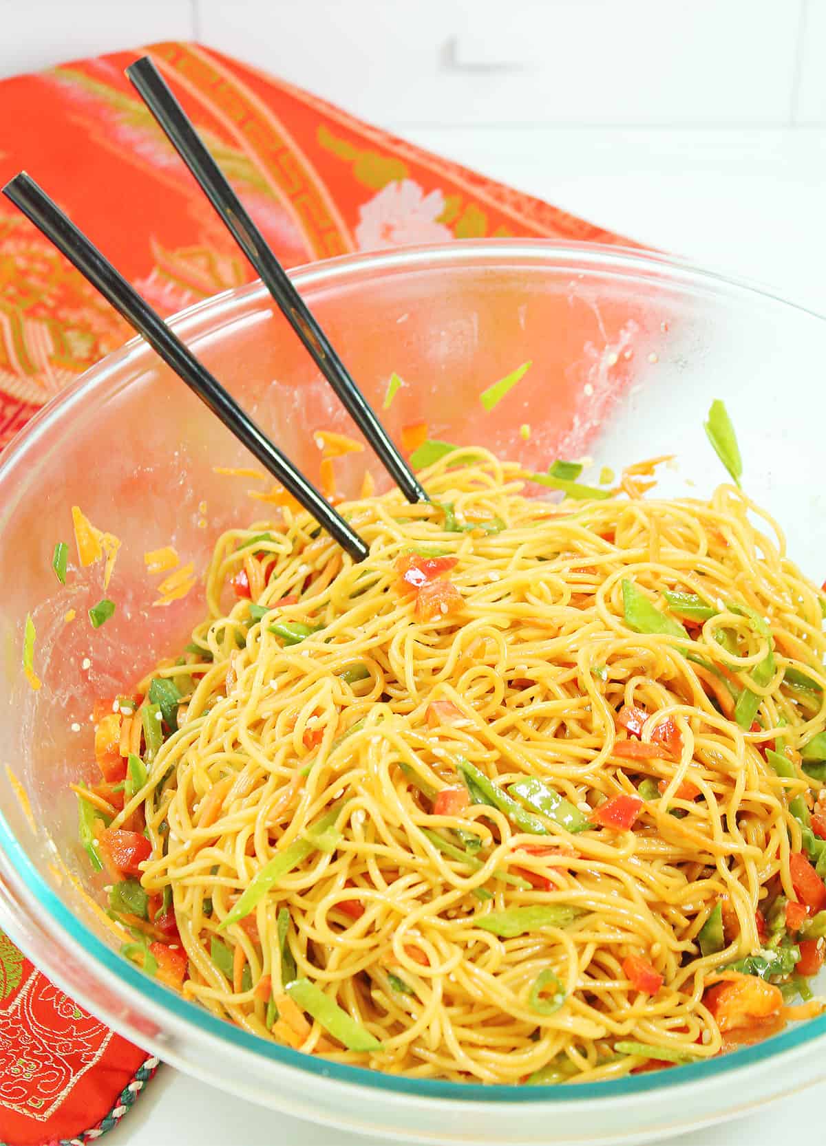 Tossed salad in bowl with chopsticks.