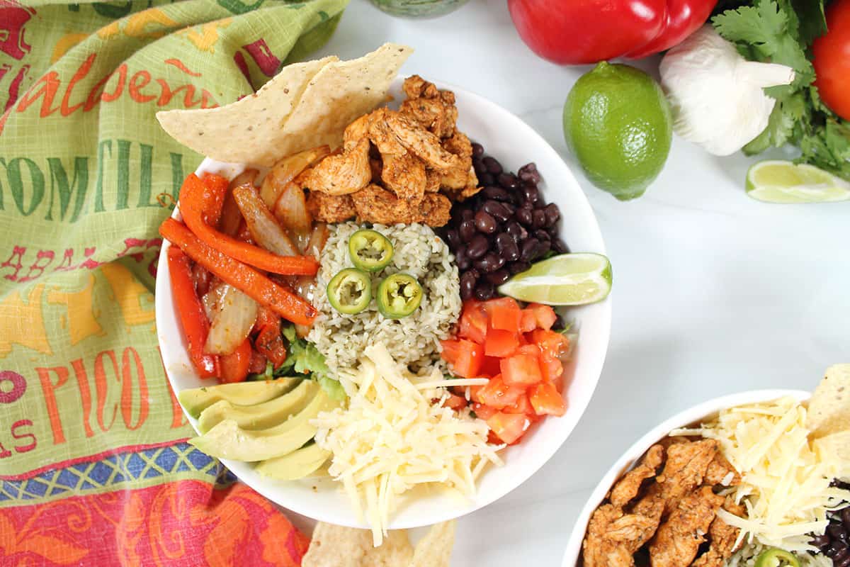 Assembling chicken fajita bowl.