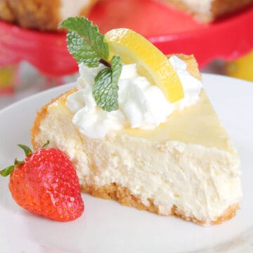 Lemon cheesecake slice with whipped cream, lemon and mint.