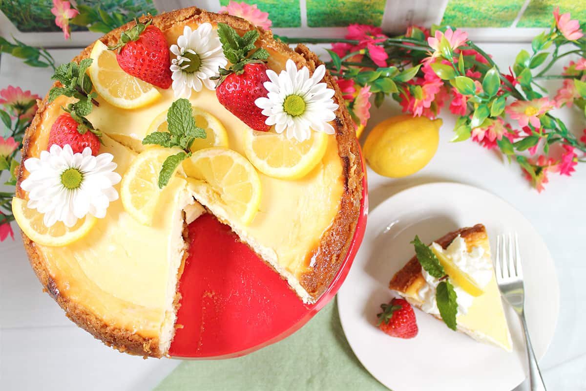 Decorated New York lemon cheesecake with slice out.