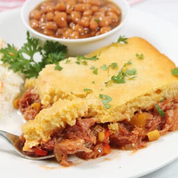 Plated pulled pork casserole with bite on fork.