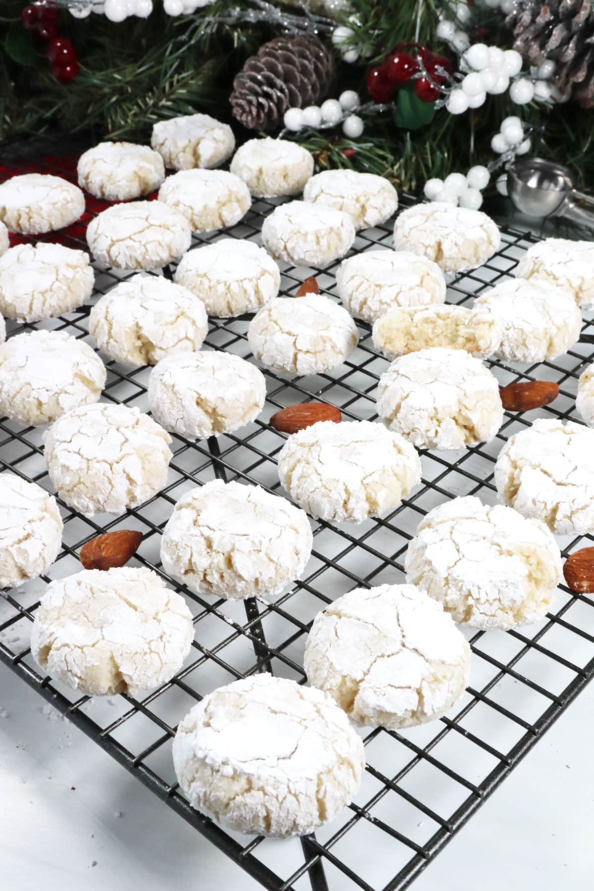 Baked almond cookies cooling on wire rack.