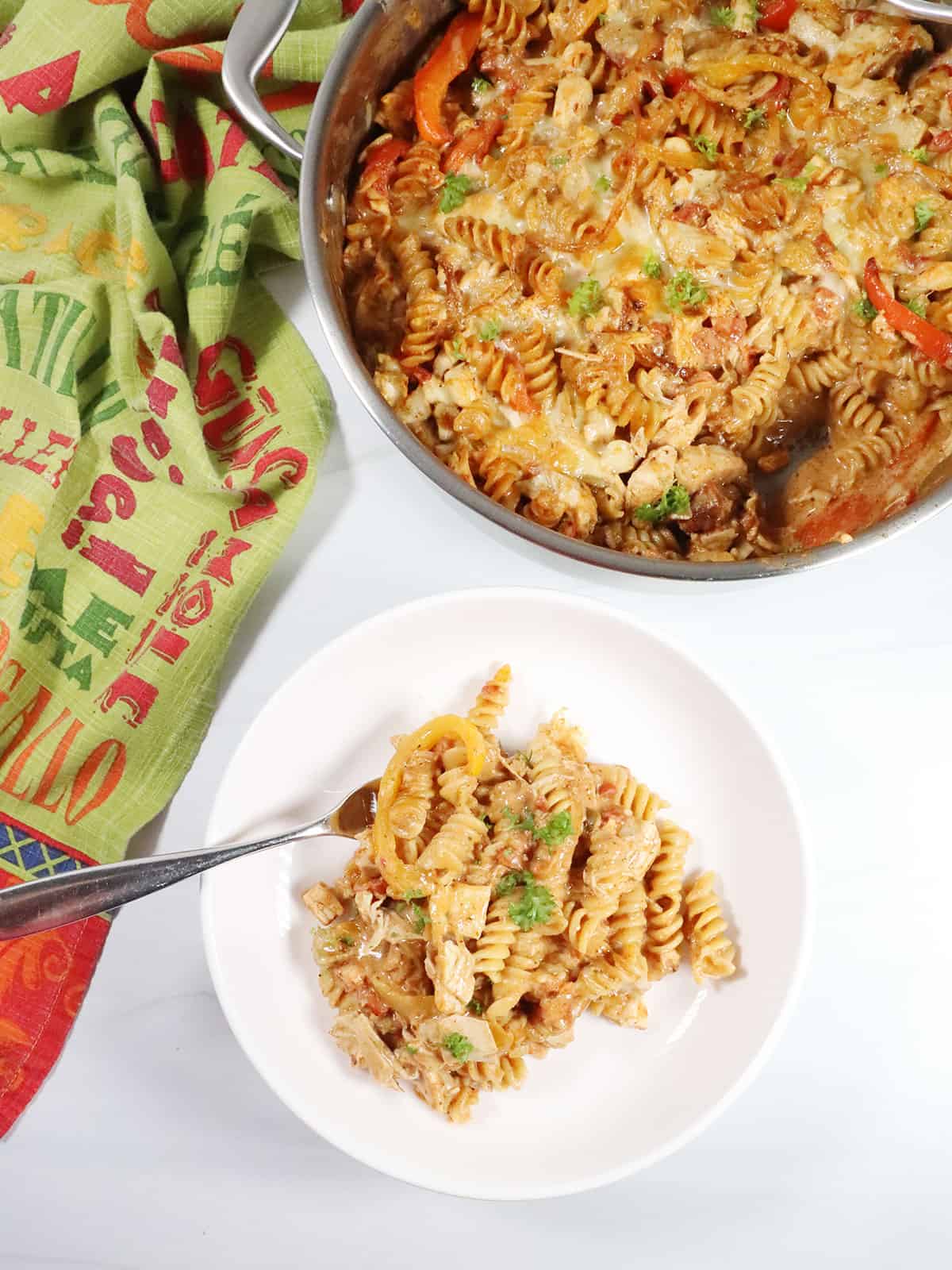 Chicken Fajita Pasta in serving bowl by skillet.