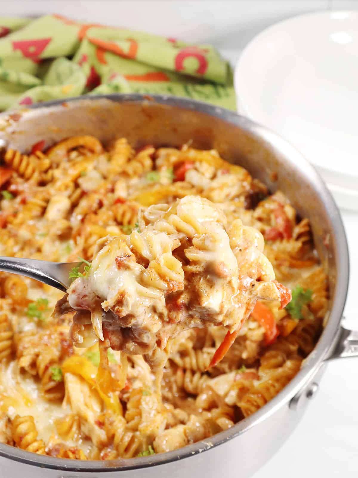Spoonful of Chicken Fajita Bake over skillet.