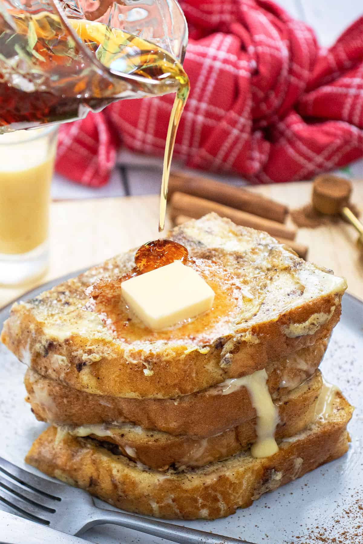 Pouring syrup over plated French Toast.