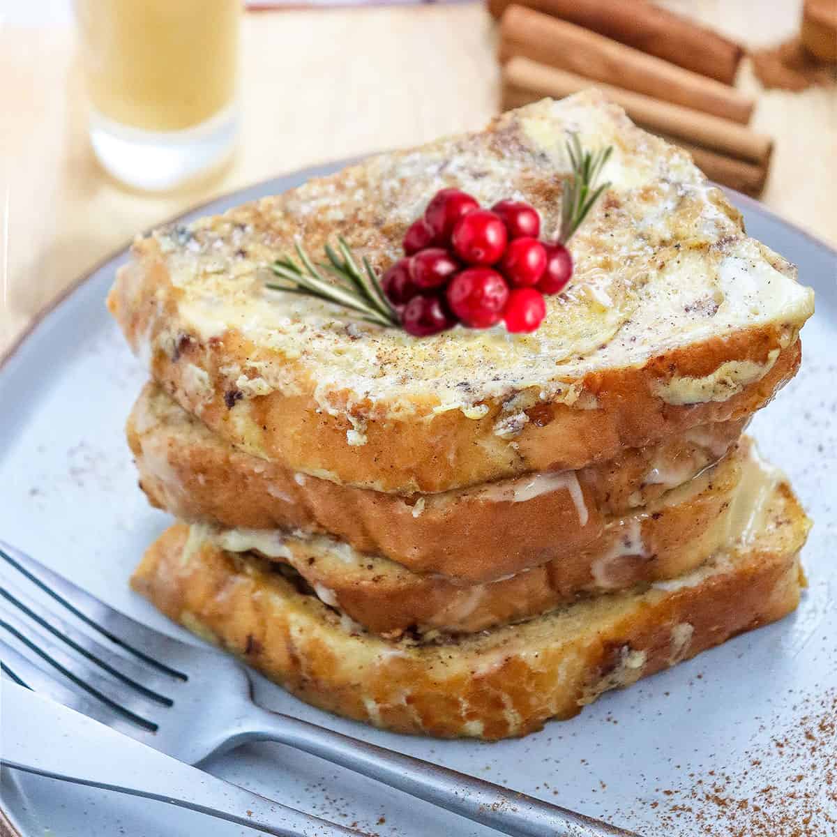 Eggnog French Toast plated with cranberry garnish.