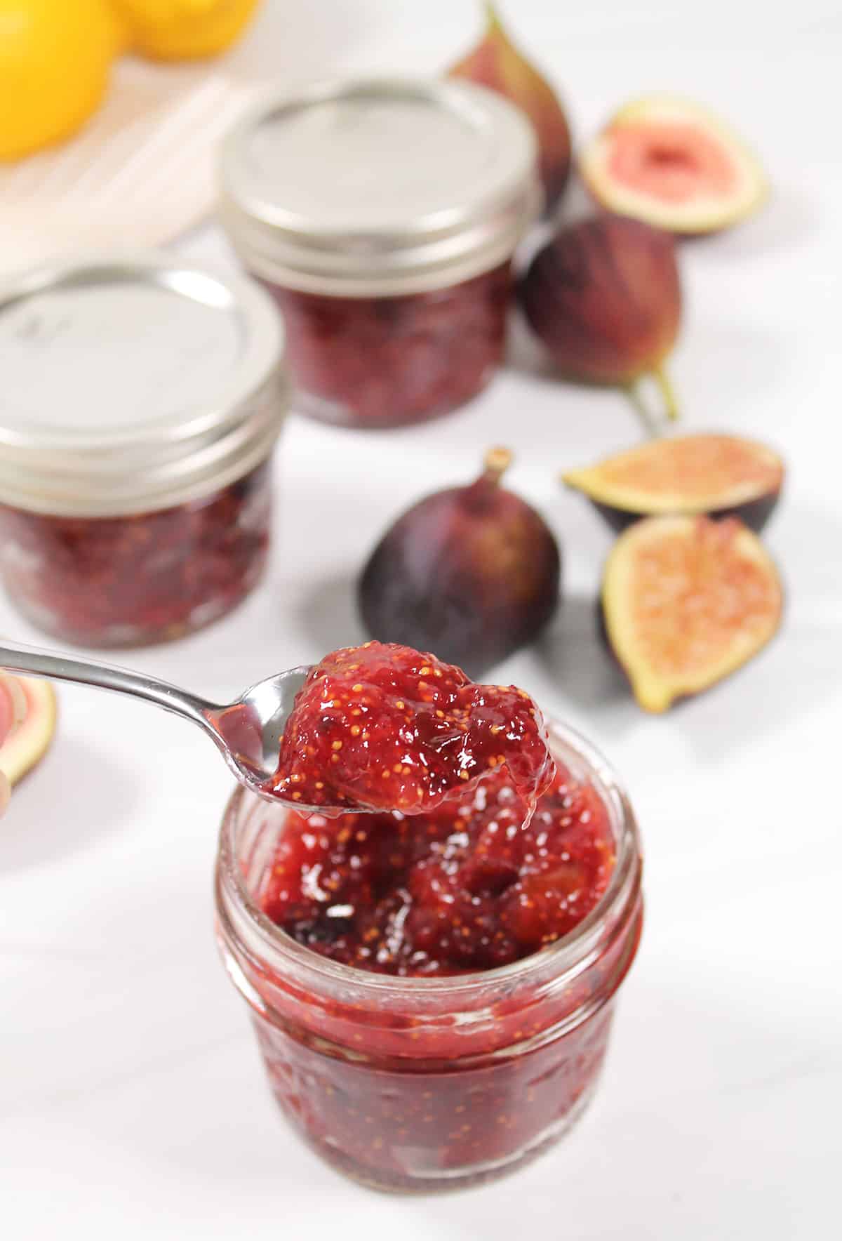 Spoonful of fig jam over jar.