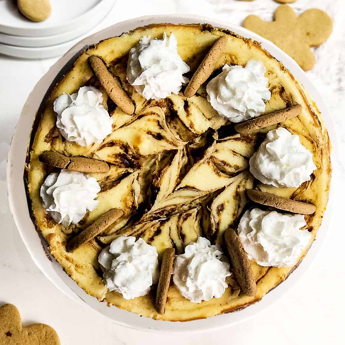 Baked cheesecake with gingersnaps and whipped cream.