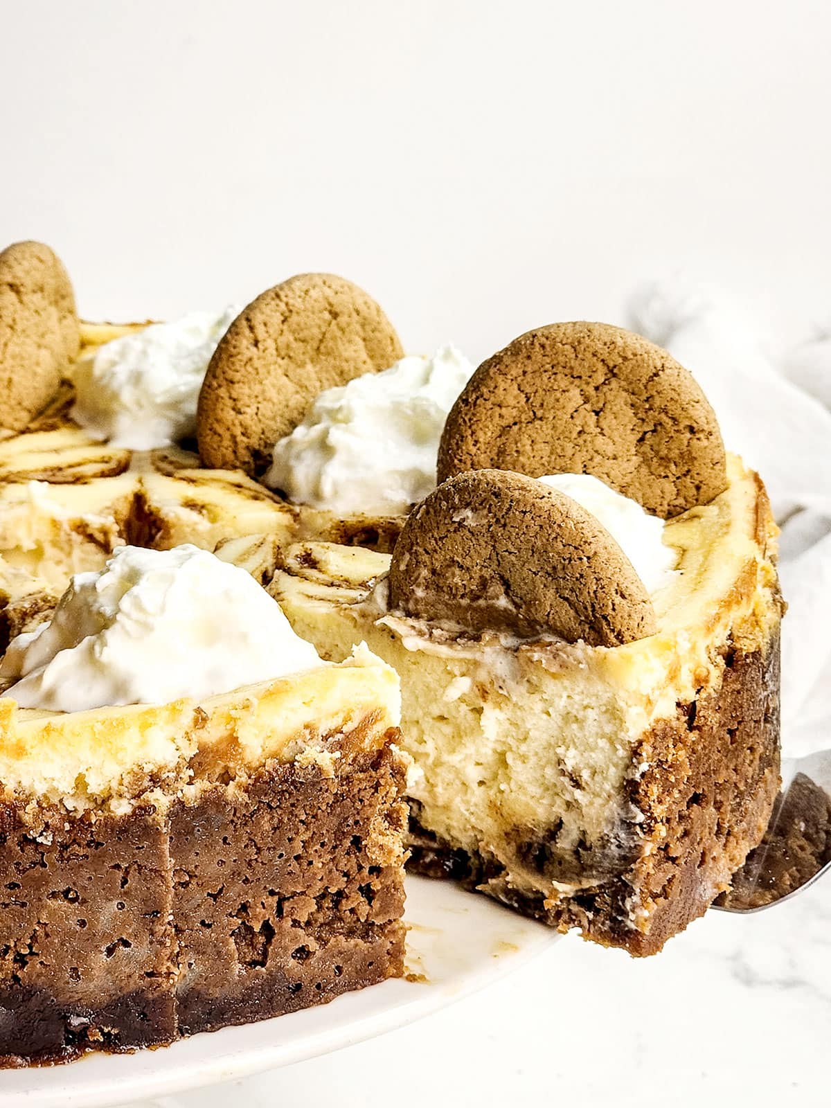 Lifting out slice of gingerbread cheesecake.