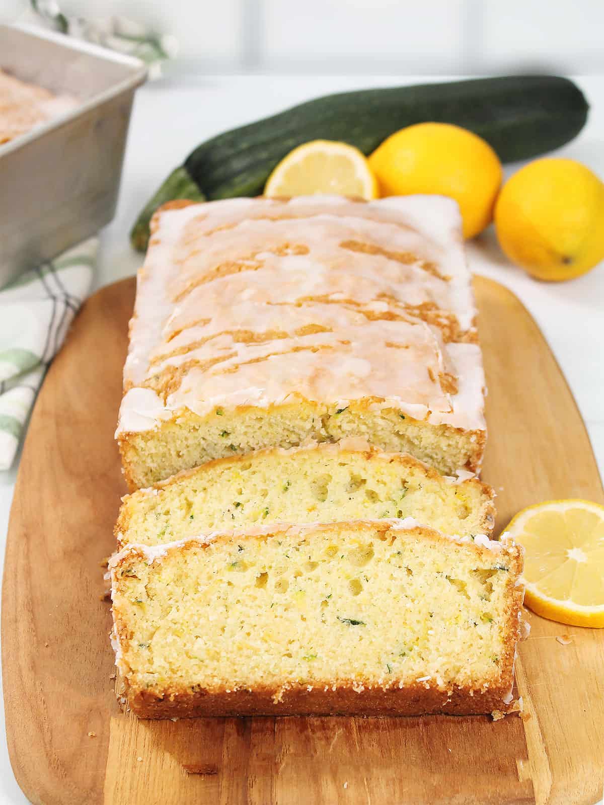 Lemon Zucchini Bread sliced on cutting board.