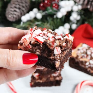 Holding a chocolate brownie with peppermint.