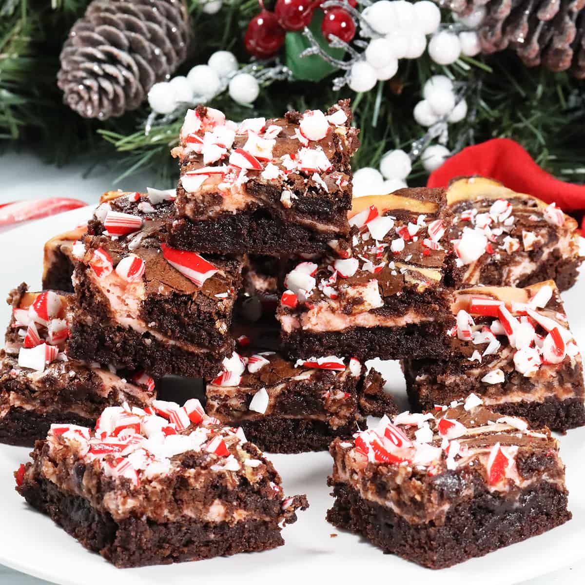Candy Cane Brownies stacked on serving plate.