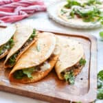 Caesar Salad Tacos meets smash burgers on wooden board.