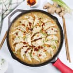 One Pan Dumpling Bake with chicken and garnish of chili crisp.