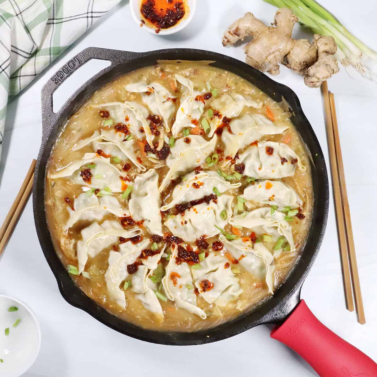 One Pan Dumpling Bake with chicken and garnish of chili crisp.
